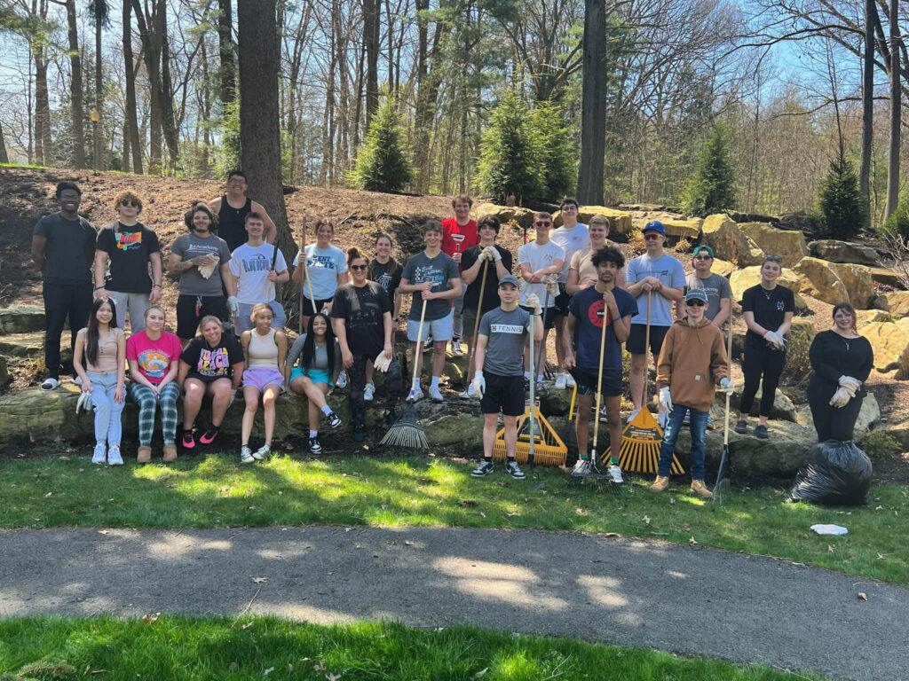 Community service members with takes outside